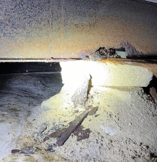Flexible ductwork running through a mobile home crawlspace